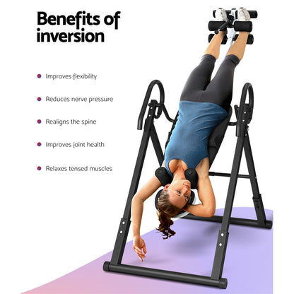 Person using Everfit Inversion Table Grey for spine decompression and back pain relief, highlighting benefits of inversion therapy.