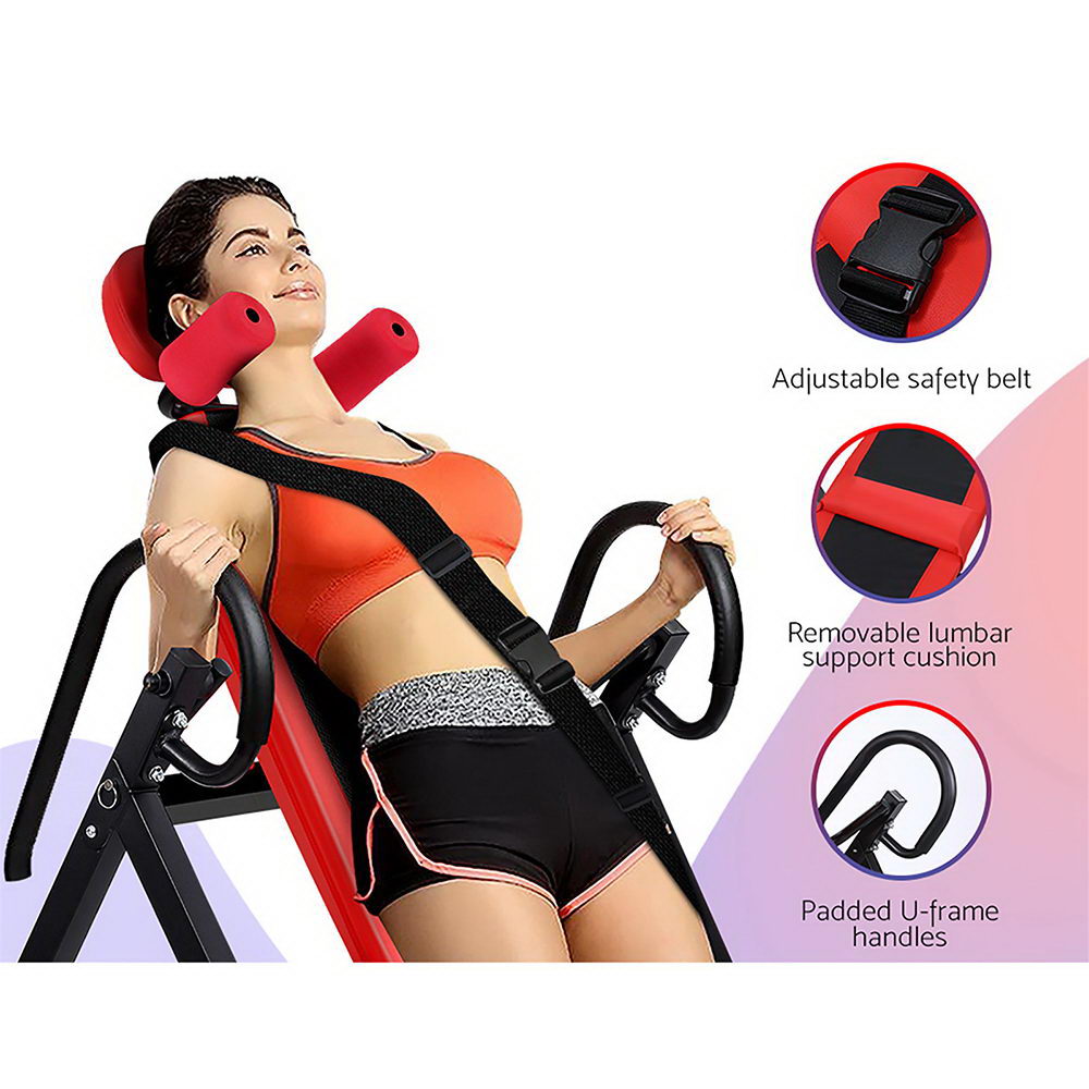 Woman using Everfit Inversion Table Red with safety belt and lumbar cushion in home gym.