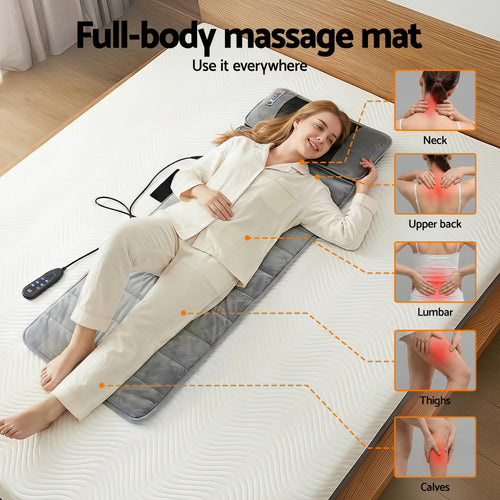Woman relaxing on a massage mat with heat and vibration, targeting neck, upper back, lumbar, thighs, and calves for total comfort.