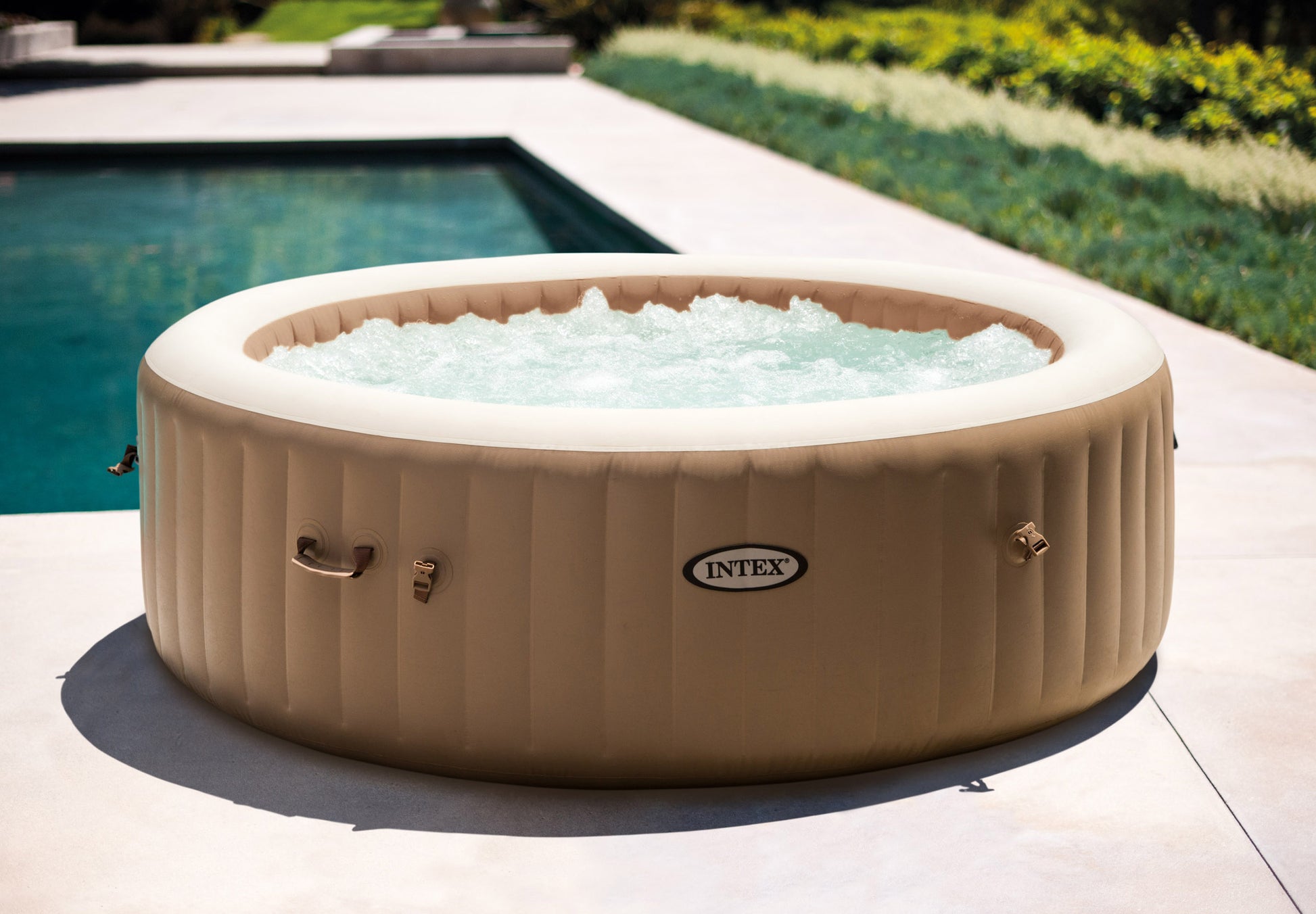 Inflatable Spa Bubble Massage 6 Person Hot Tub in a luxurious garden setting with bubbling water.