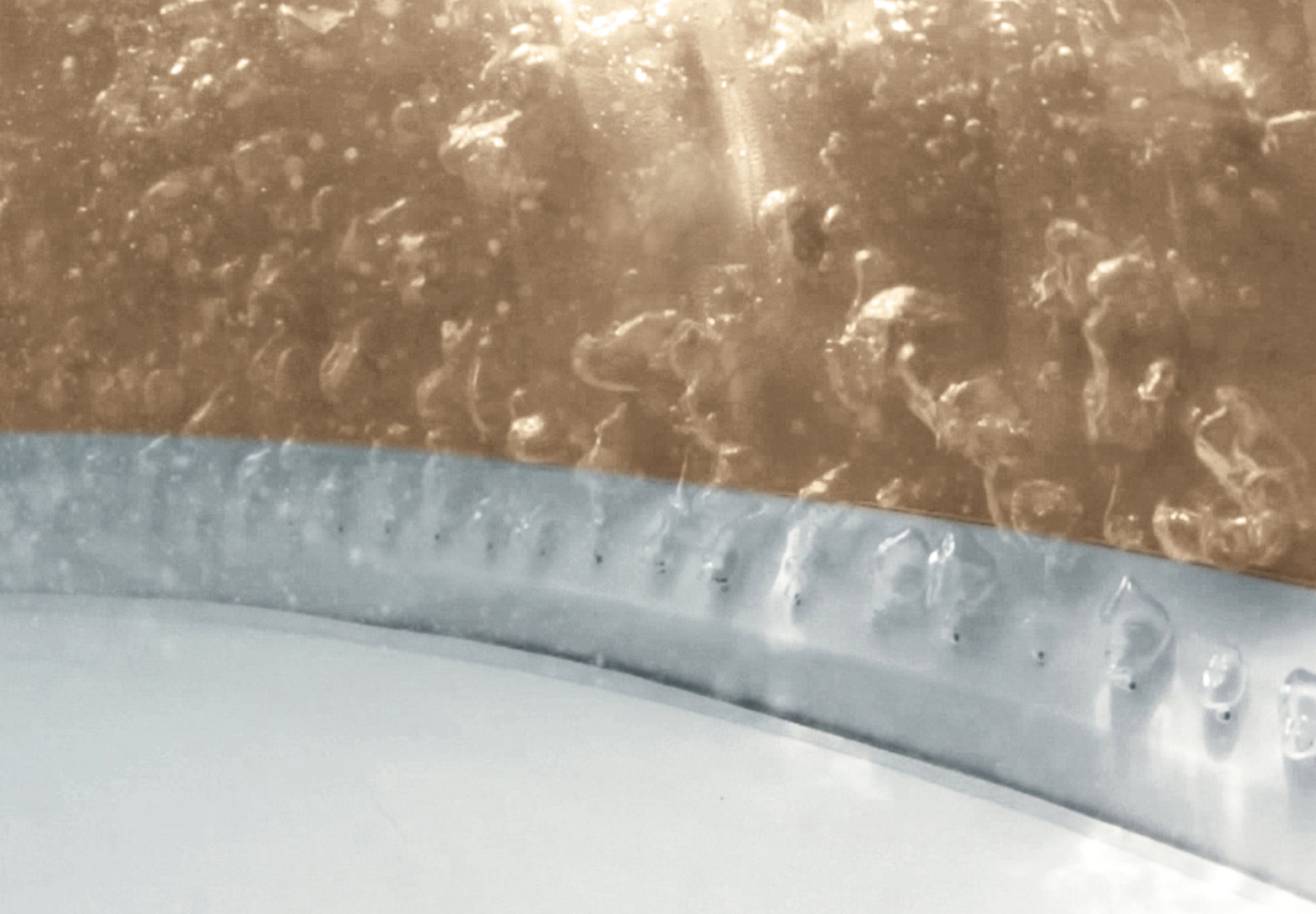 Close-up view of bubbles on an Inflatable Spa surface, showcasing the relaxation features of a six-person hot tub.