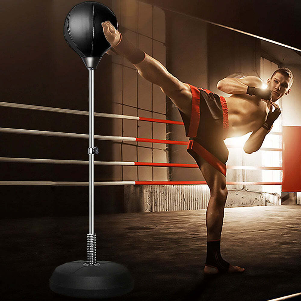 Free Standing Boxing Set with punching ball and gloves, ideal for home workouts, shown in use by a boxer in a gym setting.