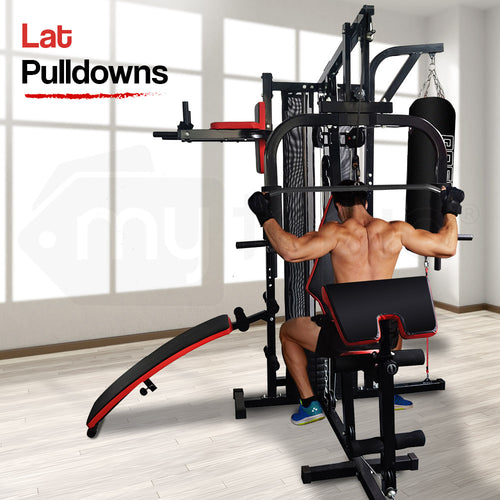 Man performing lat pulldowns on Proflex M9500 Home Gym exercise machine with integrated boxing bag.