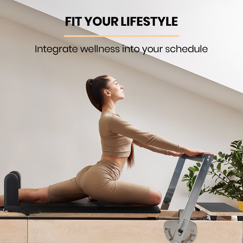 Woman using a Pilates Reformer for flexibility training at home, promoting wellness and fitness.