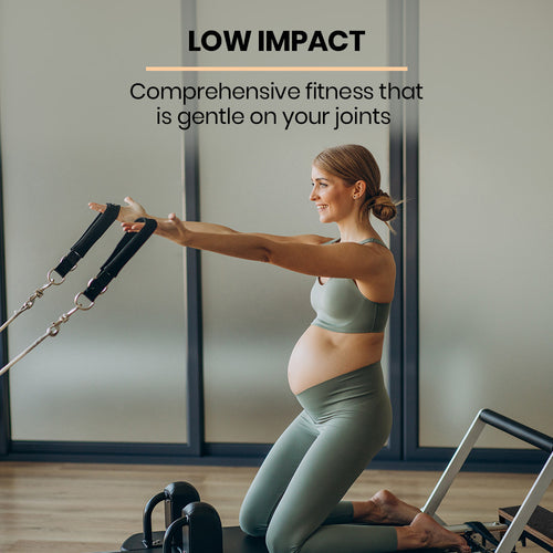 Pregnant woman using Pilates Reformer for low-impact fitness routine at home.