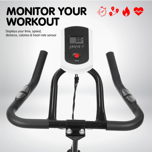 Flywheel Spin Bike console showing workout metrics including time, speed, distance, calories, and heart rate sensor.
