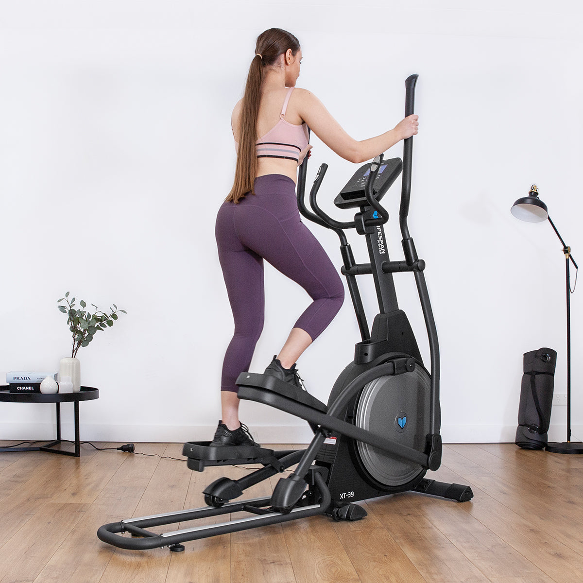 Woman exercising on Lifespan Fitness XT-39 Cross Trainer in home gym setting