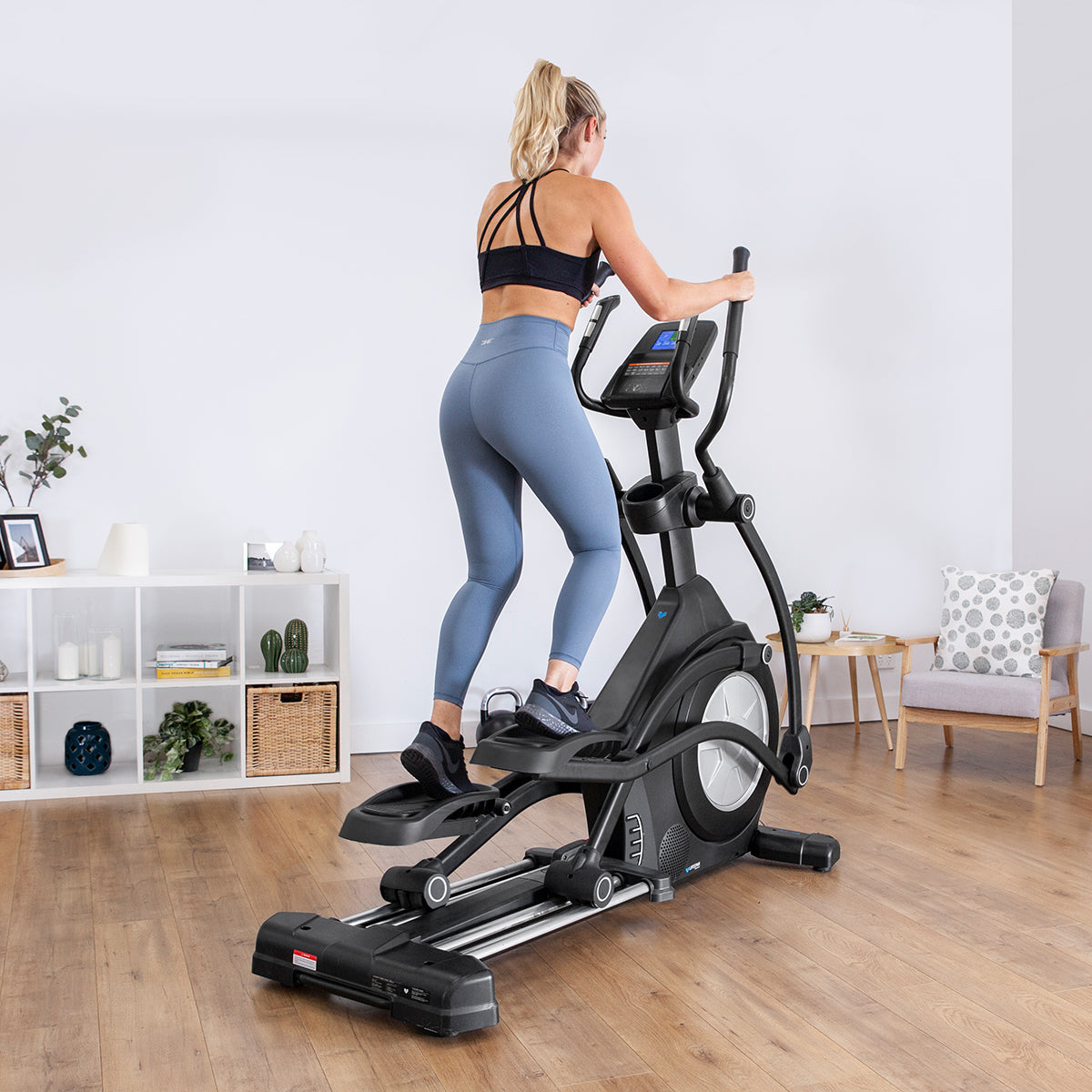 Woman exercising on Lifespan Fitness XT-40 Cross Trainer in a modern home gym setting.