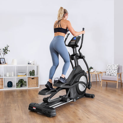 Woman exercising on Lifespan Fitness XT-40 Cross Trainer in a modern home gym setting.