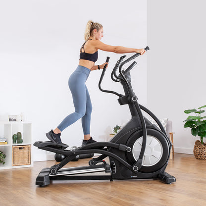 Woman exercising on Lifespan Fitness XT-40 Cross Trainer in modern living room setting