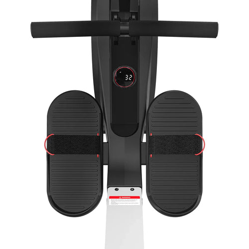 Rowing machine footrests with adjustable straps and digital display for enhanced workout experience.