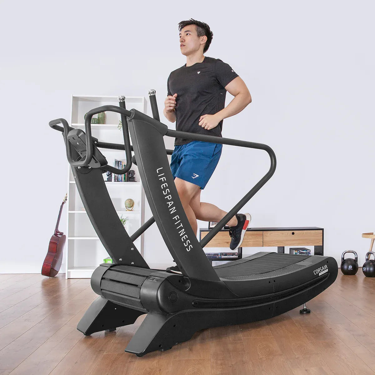 A person running on a Manual Treadmill, the Lifespan Fitness Corsair FreeRun 105, in a fitness studio.