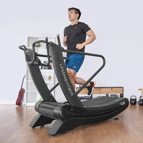 A person running on a Manual Treadmill, the Lifespan Fitness Corsair FreeRun 105, in a fitness studio.