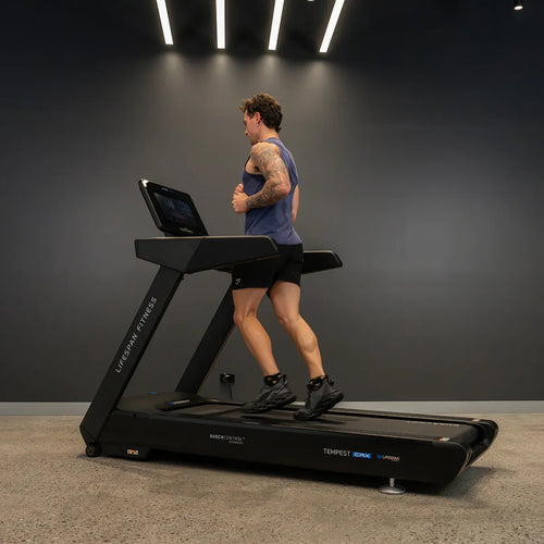 Runner using a Commercial Treadmill – Lifespan Tempest CRX Smart TFT in a modern gym setting.
