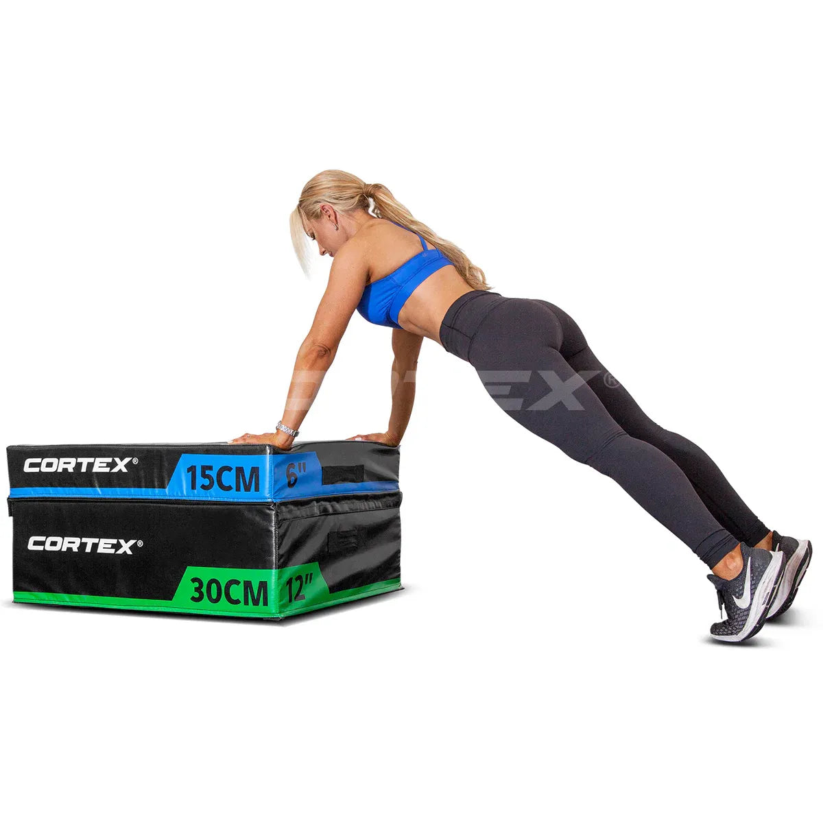 Woman performing push-ups on stackable plyo box, showcasing Cortex brand, dimensions of 15cm and 30cm.