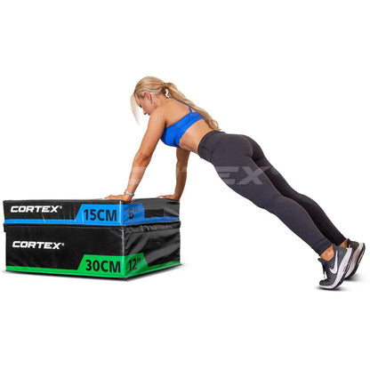 Woman performing push-ups on stackable plyo box, showcasing Cortex brand, dimensions of 15cm and 30cm.