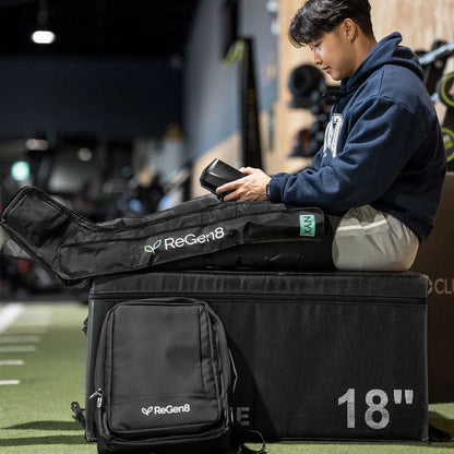 Athlete using ReGen8 Compression Recovery Boots for enhanced recovery and performance in a gym.