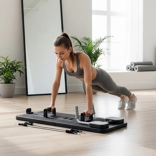 Woman using the Abdominal Board Pilates Reformer for core strength in a modern home gym.